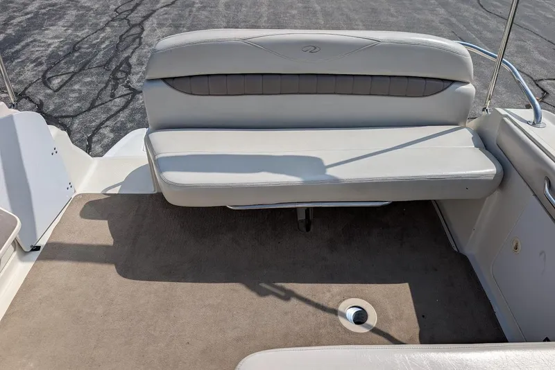 Slide: The Image of 2001 Regal Commodore 2660 boat interior with beige seating and carpet. - 13