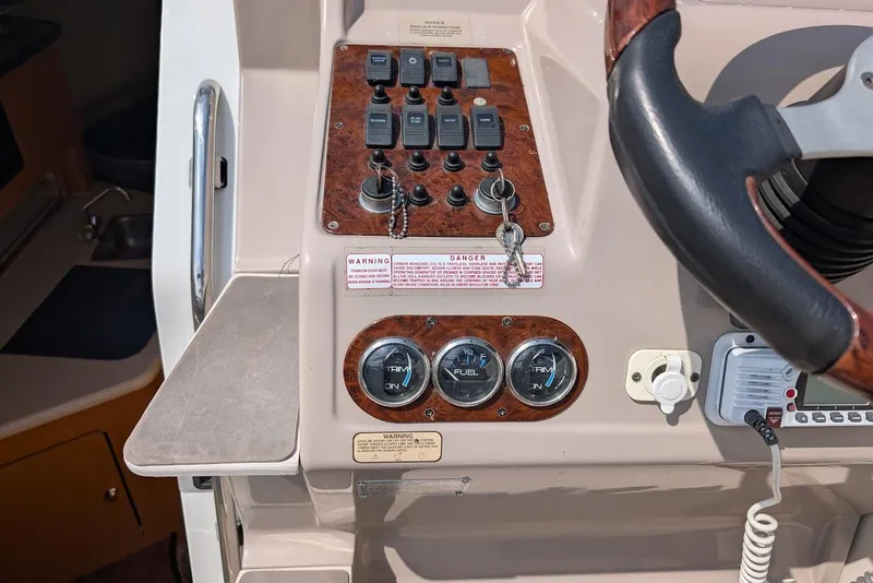 Slide: The Image of 2001 Regal Commodore 2660 boat dashboard with controls and gauges. - 21
