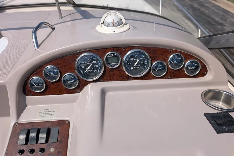 Slide: The Image of Dashboard of a 2001 Regal Commodore 2660 boat with various gauges and controls. - 22