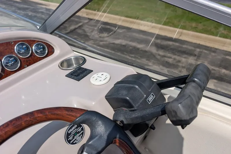 Slide: The Image of 2001 Regal Commodore 2660 boat dashboard with steering wheel and control panel. - 23