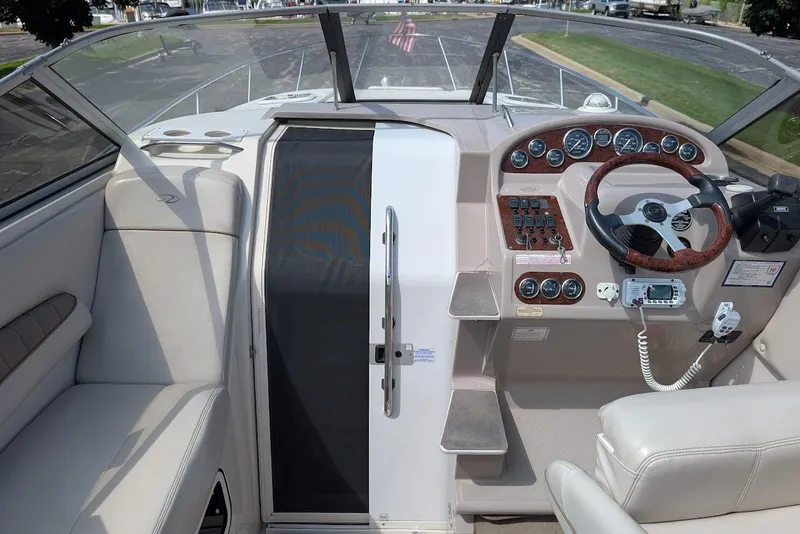 Slide: The Image of 2001 Regal Commodore 2660 boat cockpit with steering wheel and control panel. - 24