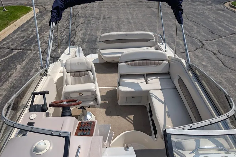 Slide: The Image of 2001 Regal Commodore 2660 boat interior with seating and steering wheel. - 26