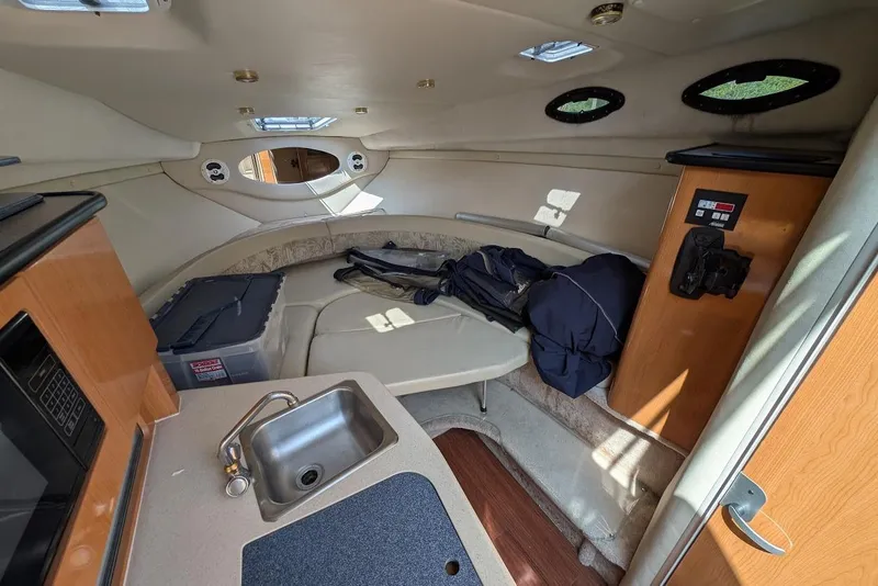 Slide: The Image of Interior of 2001 Regal Commodore 2660 boat with kitchenette and seating area. - 28