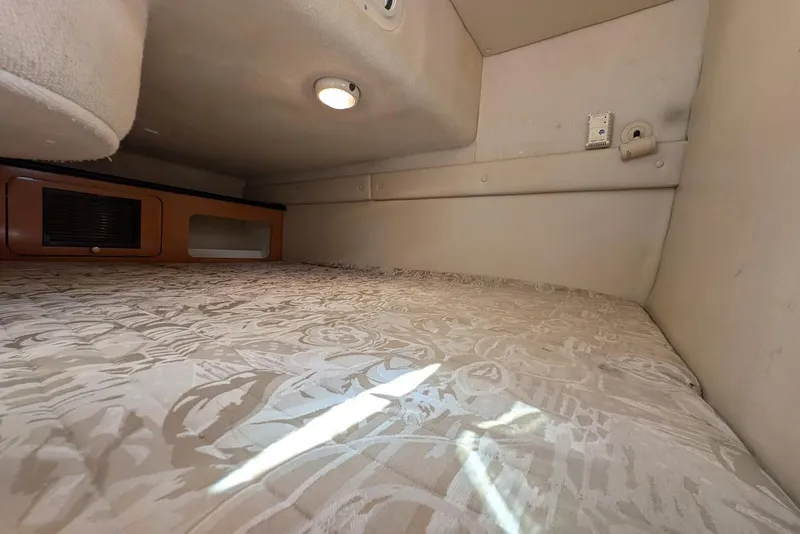 Slide: The Image of Interior cabin of 2001 Regal Commodore 2660 with patterned bedding and ambient lighting. - 31