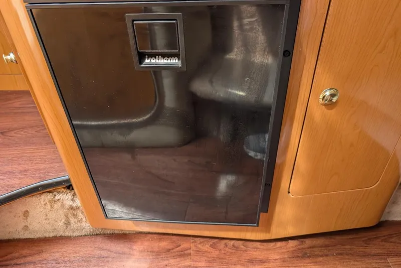 Slide: The Image of 2001 Regal Commodore 2660 interior with wooden cabinetry and black appliance. - 38