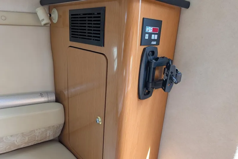 Slide: The Image of 2001 Regal Commodore 2660 interior with wooden cabinet and control panel. - 39