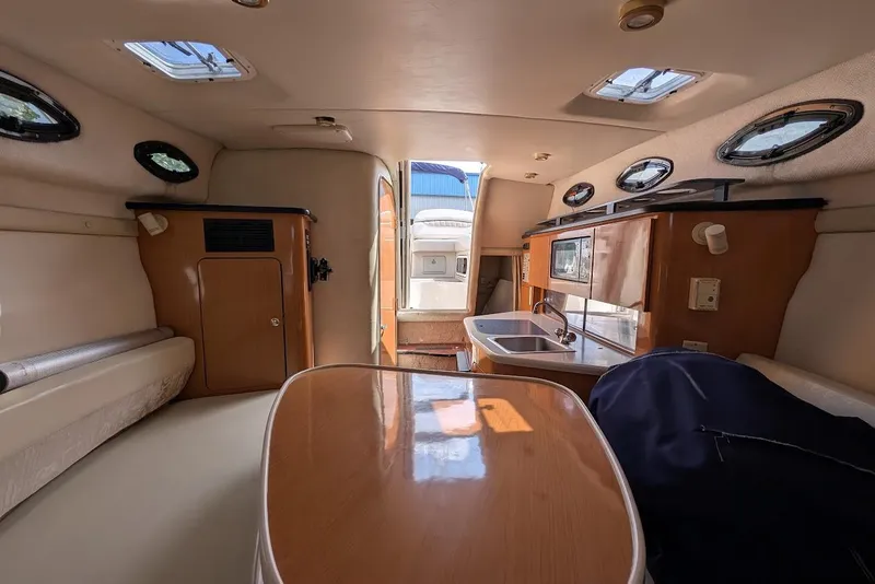 Slide: The Image of Interior of 2001 Regal Commodore 2660 boat with kitchenette and seating area. - 40