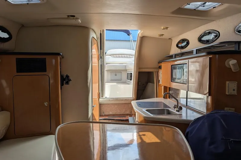 Slide: The Image of Interior of 2001 Regal Commodore 2660 boat with kitchenette and seating area. - 41