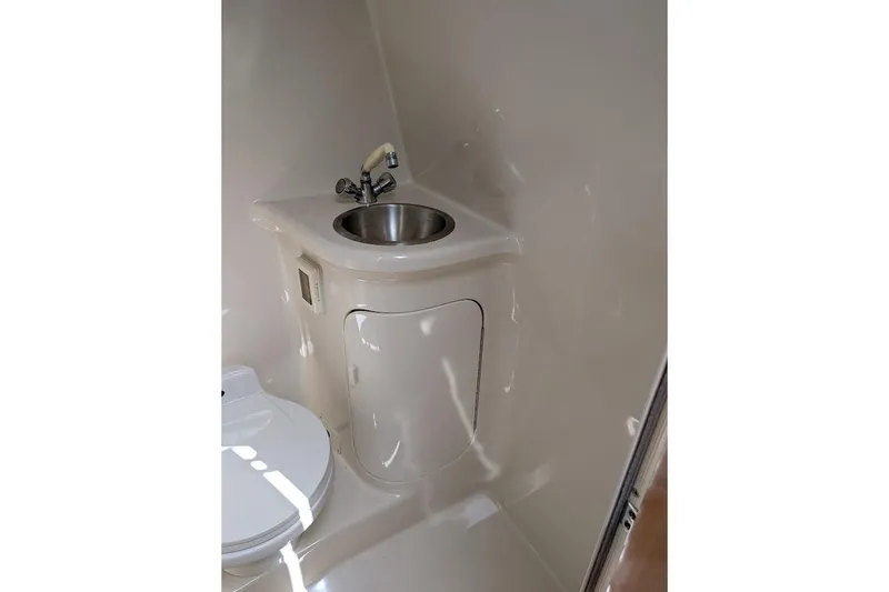 Slide: The Image of 2001 Regal Commodore 2660 boat bathroom with sink and toilet. - 43