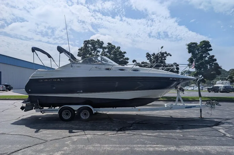 Slide: The Image of 2001 Regal Commodore 2660 boat on trailer, parked outdoors under a partly cloudy sky. - 5