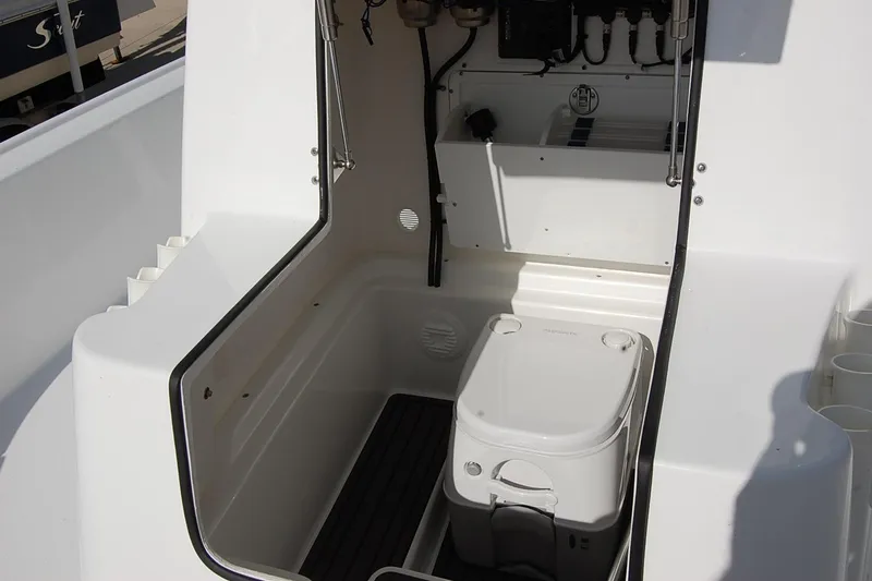 Slide: The Image of 2026 Cape Horn 23 Cape Bay boat interior with compact toilet and storage area. - 14