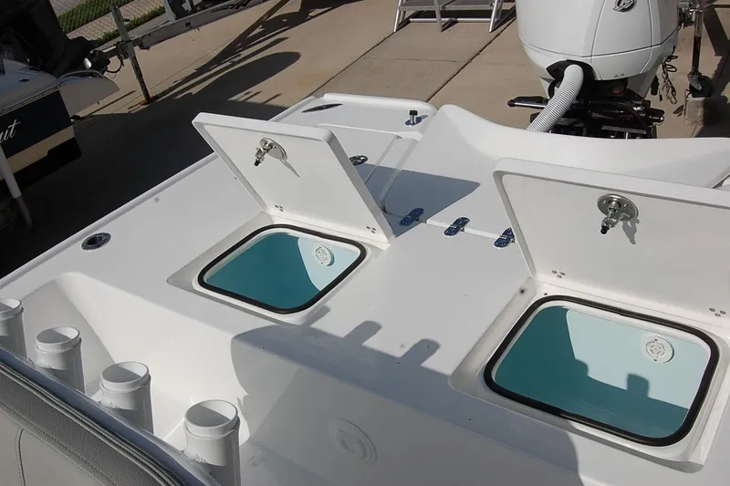 Slide: The Image of 2026 Cape Horn 23 Cape Bay boat with open storage compartments and rod holders. - 20