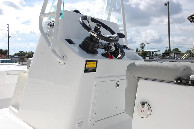 Slide: The Image of 2026 Cape Horn 23 Cape Bay boat console with steering wheel and seating. - 10