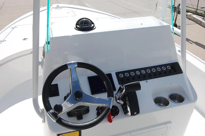 Slide: The Image of 2026 Cape Horn 23 Cape Bay boat console with steering wheel and controls. - 11