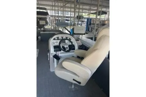 Slide: The Image of 2023 PlayCraft 27 Infinity boat helm with beige captain's chair and control panel. - 11