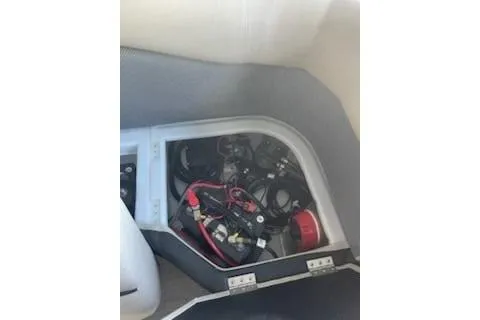 Slide: The Image of 2023 PlayCraft 27 Infinity boat battery compartment with wiring and components. - 4