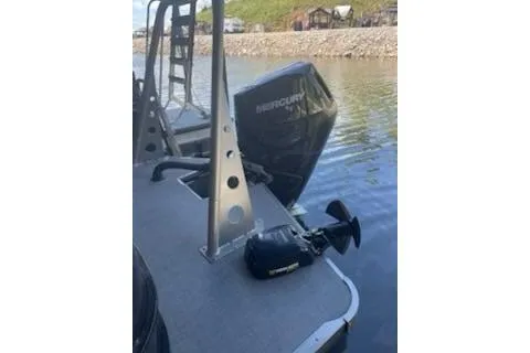 Slide: The Image of 2023 PlayCraft 27 Infinity boat with Mercury outboard motor on a calm lake. - 8