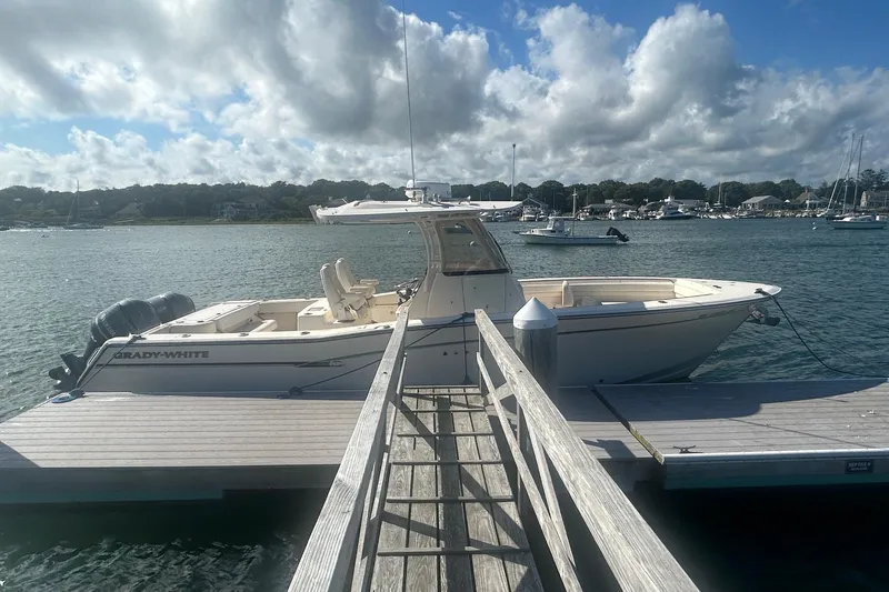 Slide: The Image of 2017 Grady-White Canyon 306 boat docked on a sunny day with cloudy sky. - 1