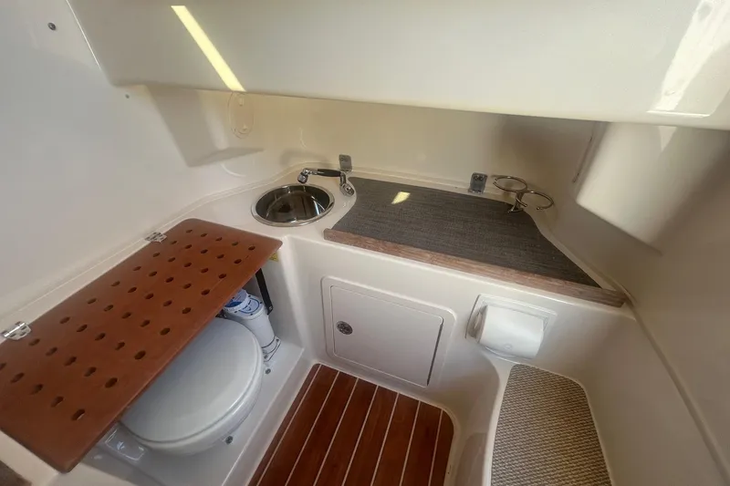 Slide: The Image of 2017 Grady-White Canyon 306 boat interior with sink, toilet, and wooden flooring. - 13