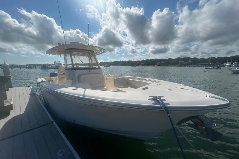Slide: The Image of 2017 Grady-White Canyon 306 boat docked under a partly cloudy sky. - 3