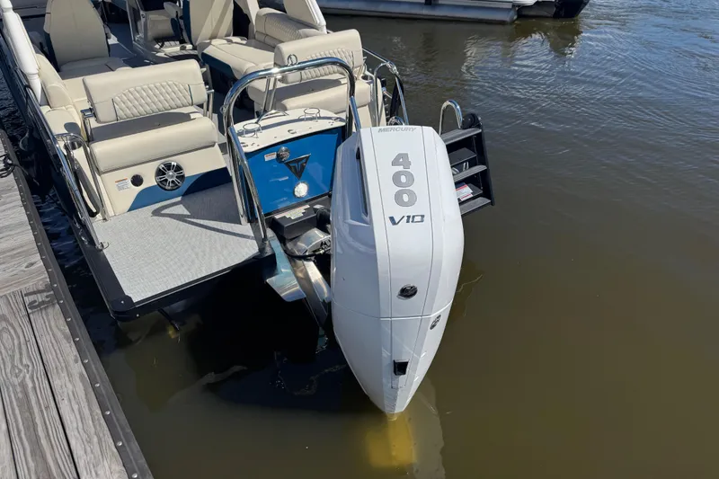Slide: The Image of 2026 Tahoe Pontoon Grand Tahoe LTD Quad Lounge with Mercury 400 V10 engine at dock. - 14