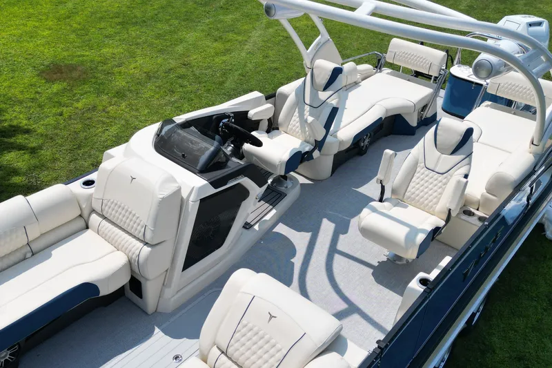 Slide: The Image of 2026 Tahoe Pontoon Grand Tahoe LTD Quad Lounge with luxurious seating on green grass. - 3