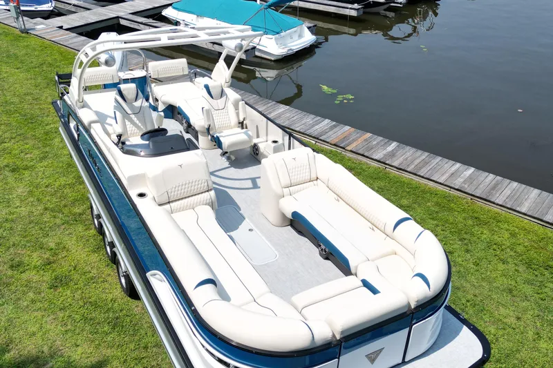 Slide: The Image of 2026 Tahoe Pontoon Grand Tahoe LTD Quad Lounge on grassy lakeside dock. - 5