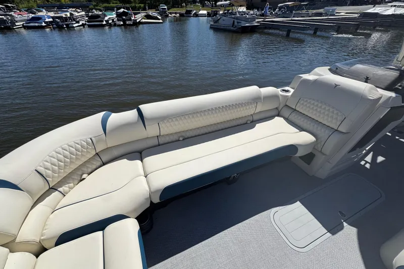 Slide: The Image of Luxurious seating on 2026 Tahoe Pontoon Grand Tahoe LTD Quad Lounge by the marina. - 7