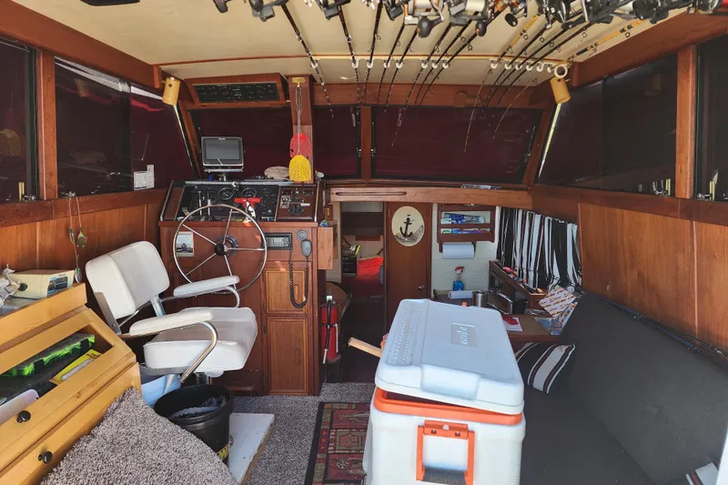 Slide: The Image of Interior of 1989 Marinette 32 Sedan Flybridge with fishing gear and seating area. - 13