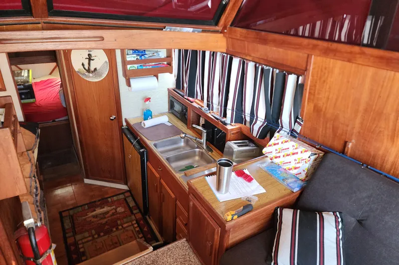 Slide: The Image of Interior of 1989 Marinette 32 Sedan Flybridge with kitchen and seating area. - 15