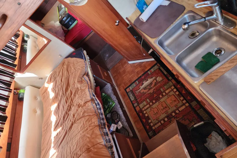 Slide: The Image of Interior of 1989 Marinette 32 Sedan Flybridge with bed, sink, and wooden cabinetry. - 16