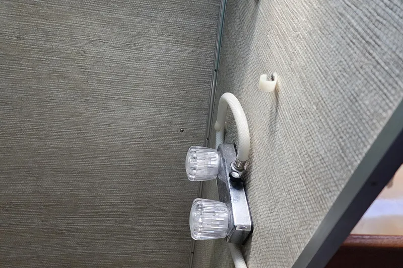 Slide: The Image of 1989 Marinette 32 Sedan Flybridge interior with dual faucet handles and textured wall. - 20