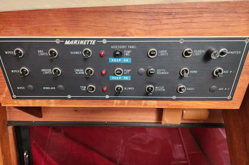 Slide: The Image of Control panel of a 1989 Marinette 32 Sedan Flybridge boat with various switches. - 29