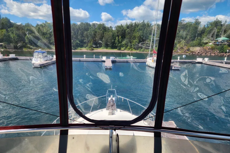 Slide: The Image of View from 1989 Marinette 32 Sedan Flybridge, docked at a scenic marina. - 8