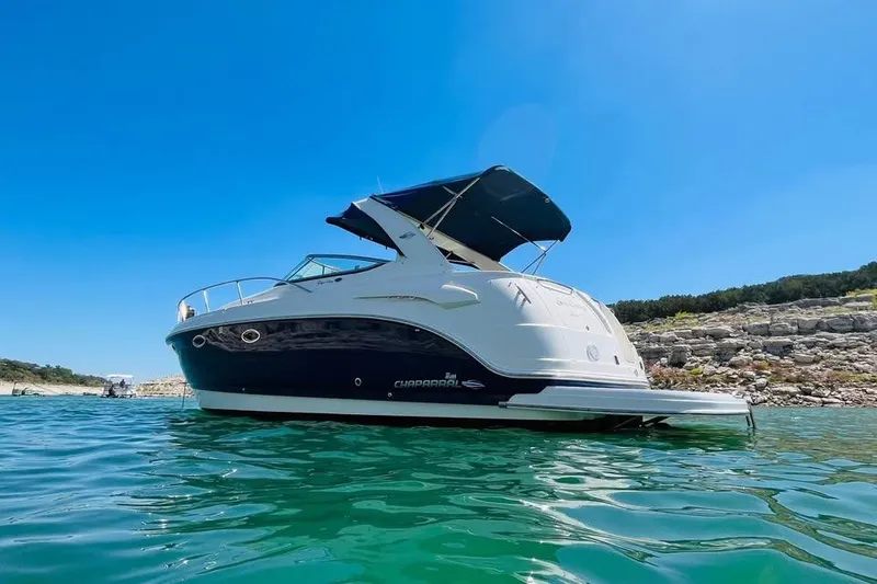 Slide: The Image of 2008 Chaparral 330 Signature boat on clear water under a bright blue sky. - 3