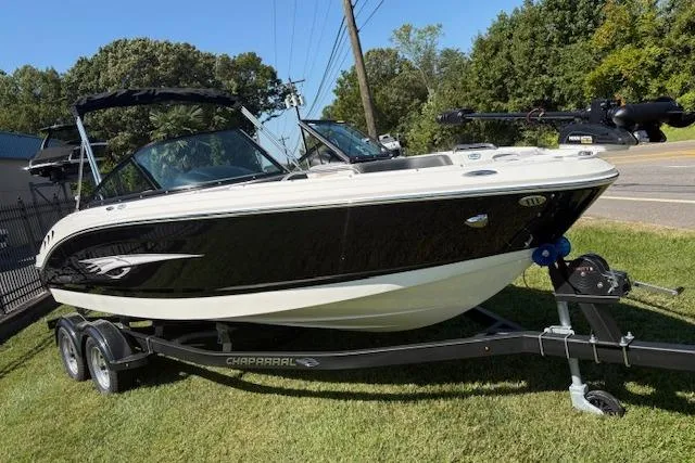 Slide: The Image of 2026 Chaparral 21 SSi Ski & Fish boat on trailer, parked on grass. - 2