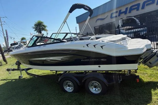 Slide: The Image of 2026 Chaparral 21 SSi Ski & Fish boat on trailer, parked outdoors. - 3