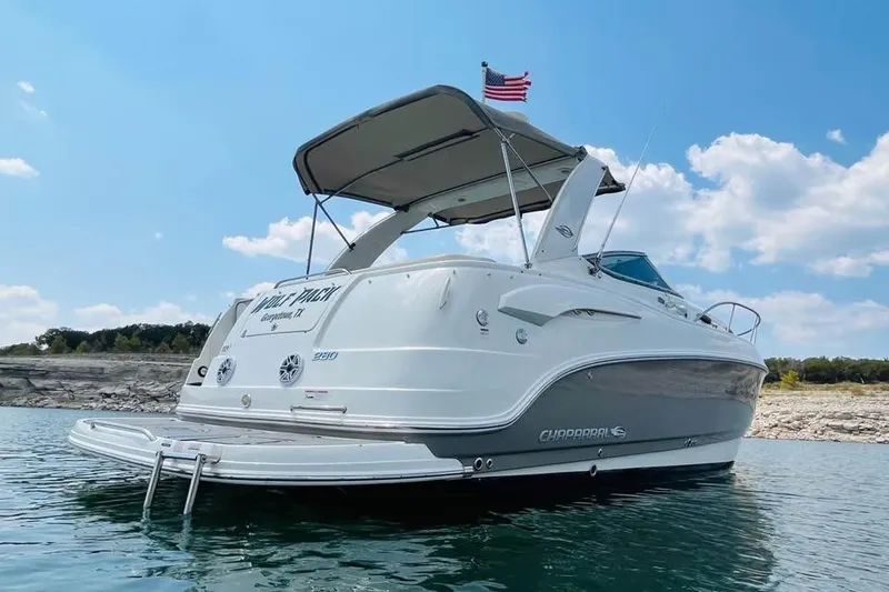 Slide: The Image of 2009 Chaparral Signature 280 boat on water, under clear blue sky. - 3
