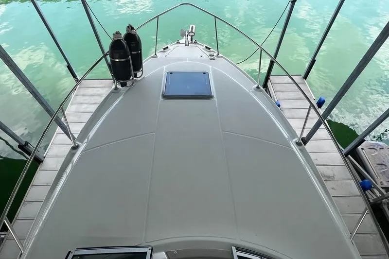 Slide: The Image of 2009 Chaparral Signature 280 boat docked on calm water, viewed from the bow. - 5