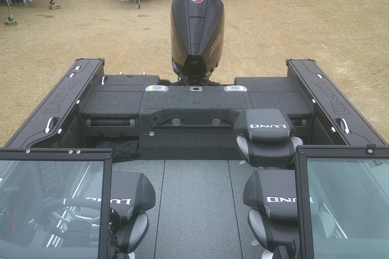 Slide: The Image of 2025 Lund 1875 Pro-V boat interior with seating and motor, viewed from above. - 14