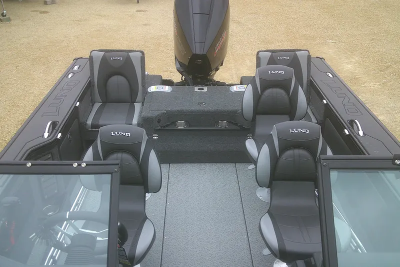 Slide: The Image of 2025 Lund 1875 Pro-V boat interior with seating and motor, showcasing modern design. - 15