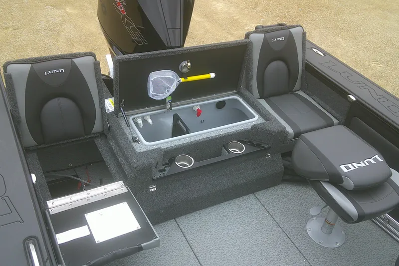 Slide: The Image of 2025 Lund 1875 Pro-V boat interior with seating, storage, and fishing equipment. - 18