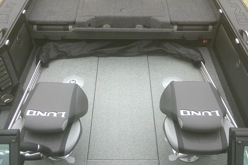 Slide: The Image of 2025 Lund 1875 Pro-V boat interior with two seats and carpeted flooring. - 5