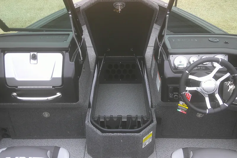 Slide: The Image of 2025 Lund 1875 Pro-V boat interior with steering wheel and storage compartments. - 8