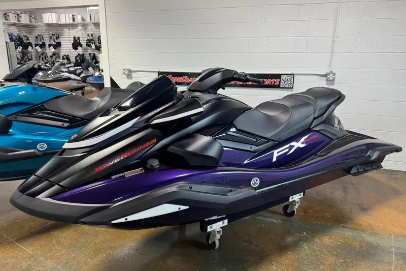 The Image of 2026 Yamaha WaveRunner FX SVHO jet ski in showroom, sleek black and purple design. - 0