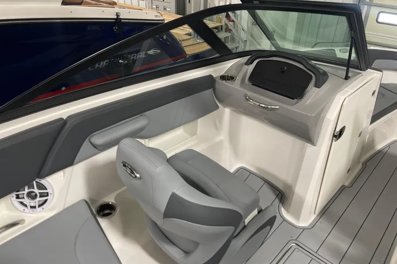 Slide: The Image of 2026 Chaparral 23 SSi boat interior with gray seating and modern dashboard design. - 7
