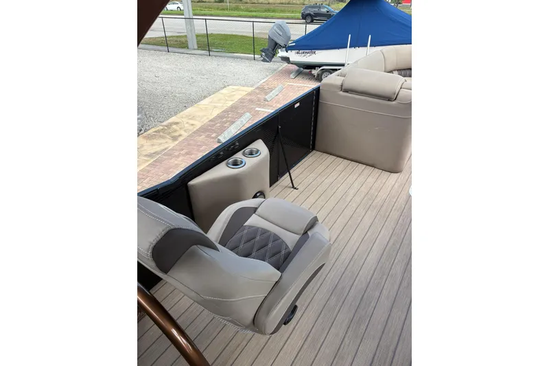 Slide: The Image of 2019 Bennington 25 QSBA boat interior with plush seating and cup holders. - 10