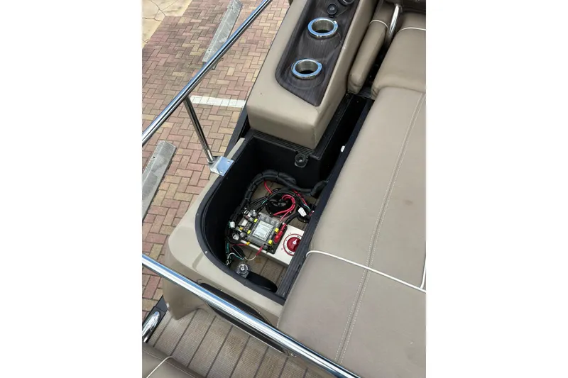 Slide: The Image of 2019 Bennington 25 QSBA boat interior showing storage compartment and electrical components. - 11