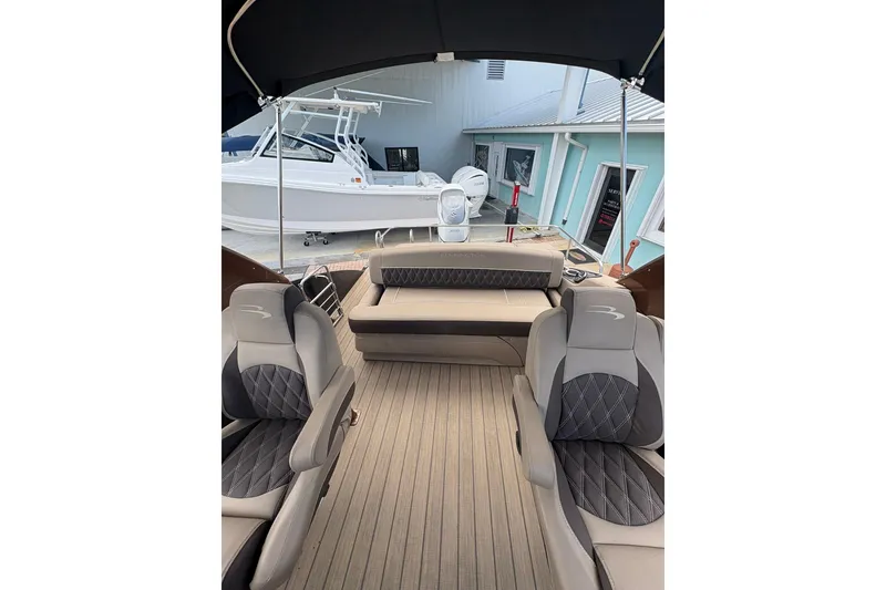 Slide: The Image of 2019 Bennington 25 QSBA boat interior with luxurious seating and canopy. - 13