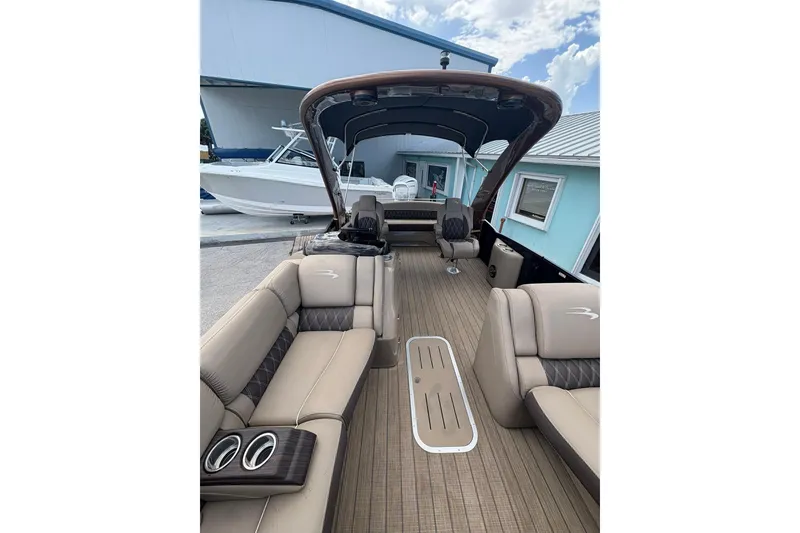 Slide: The Image of 2019 Bennington 25 QSBA pontoon boat interior with luxurious seating and spacious deck. - 16